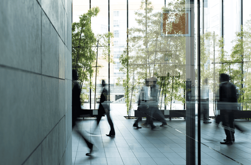 patrons walk back and forth through a modern hotel lobby